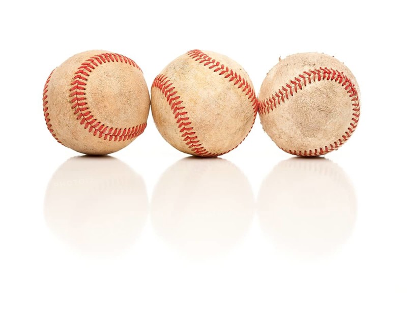 Three Baseballs Isolated on a Reflective White Background