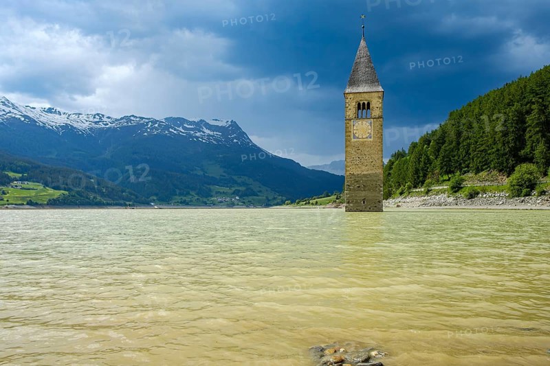 Bell tower of the former parish church of St Catherine in the sunken village of Alt-Graun in Lake Reschen in Vinschgau, South Tyrol, Italy