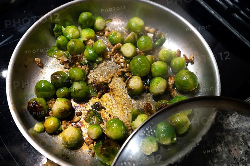 Brussels sprouts (Brassica oleracea var. gemmifera) sautéed with walnuts in a pan, Bavaria, Germany
