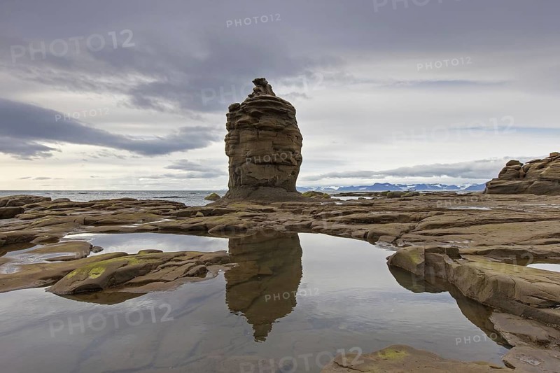 Sandstone rock formation on beach along the coast of Boltodden, Kvalvagen, Svalbard, Spitsbergen, Norway
