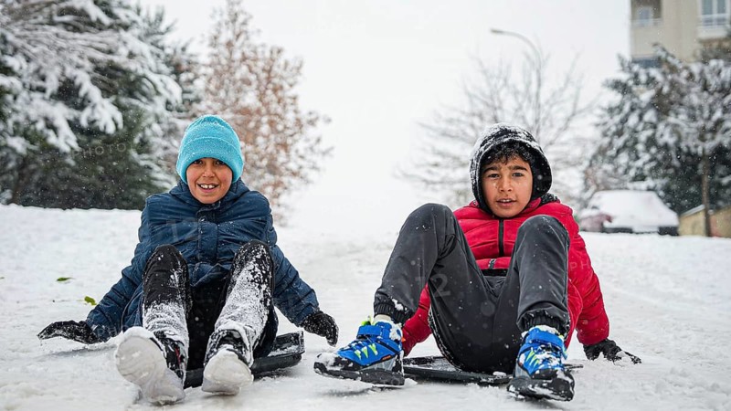 In Gaziantep, Turkey, on December 31, 2025, children and families enjoy winter activities as they play on snow-covered areas and slide on icy hills, creating a lively atmosphere across the city during the final day of the year, Gaziantep, Gaziantep, Turkey