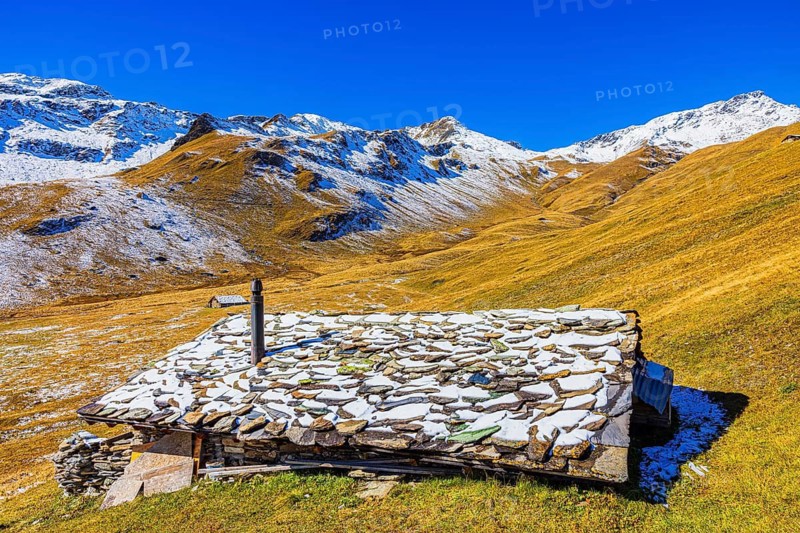 Alpine huts and lightly snow-covered alpine meadows, near Grimentz, Val d'Anniviers, Valais Alps, Canton Valais, Switzerland