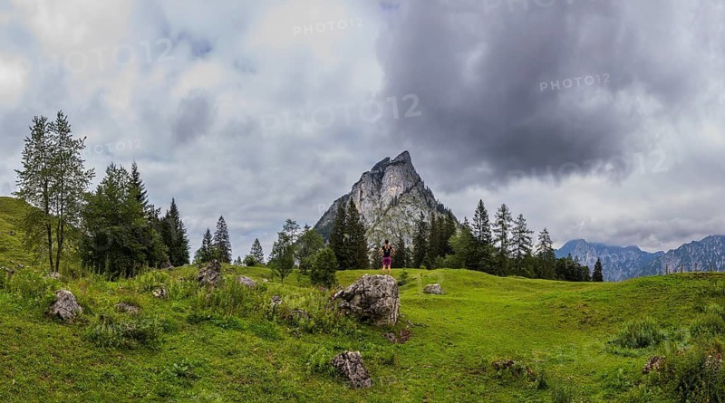 Hiker on the Schartenalm with a view of the Sparber, Osterhorn group, Salzkammergut, Salzburg province, Austria