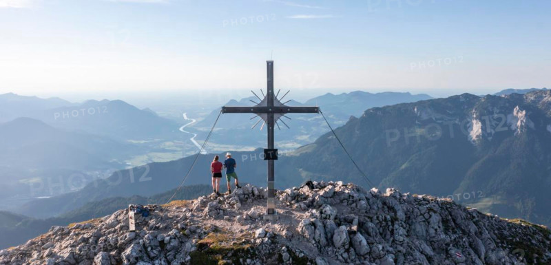 Two hikers at the summit, aerial view, evening mood in the mountains, summit cross of the Schaffauer, Wilder Kaiser, Tyrol, Austria