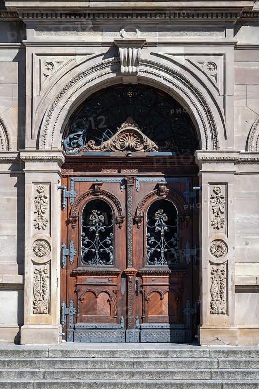 Magnificent wooden door from Alexander von Humboldt Gymnasium with artistic carvings and decorative metal ornaments decorative metal ornaments in the historic old town of Constance, traditional craftsmanship, district of Constance, Baden-Württemberg, Germany
