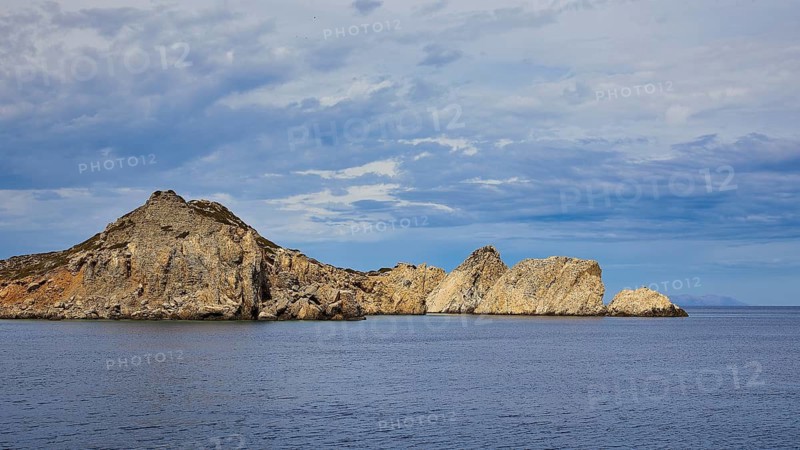 Barren rocks rise from the calm sea under a slightly cloudy sky, boat tour Saria, Saria Island, Karpathos, Dodecanese, Greek Islands, Greece