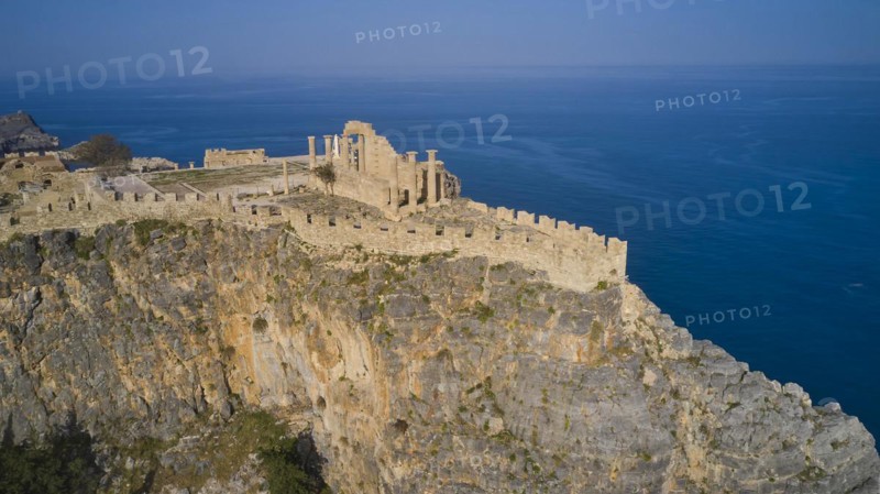 Drone shot, Acropolis of Lindos, Late afternoon light, Remains of an ancient fortress on a high cliff overlooking the sea, Archaeological site, Lindos, Rhodes, Dodecanese, Greek Islands, Greece