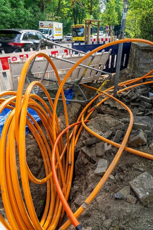 Laying of fibre optic cables, empty conduits are laid under a pavement, in which the actual fibre optic cable is later blown in and connected to the respective house connection or distributor. Essen, North Rhine-Westphalia, Germany