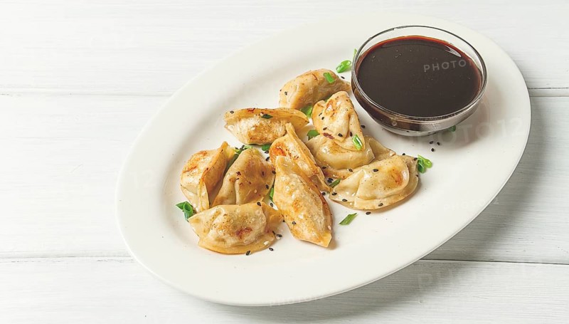 Japanese fried gyoza dumplings, with pork, sesame seeds, green onions
