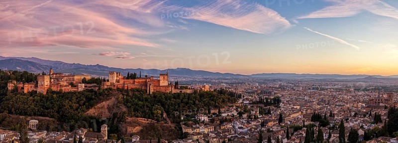 Panorama from a distance of the Alhambra and the city in the warm light of sunset, Granada