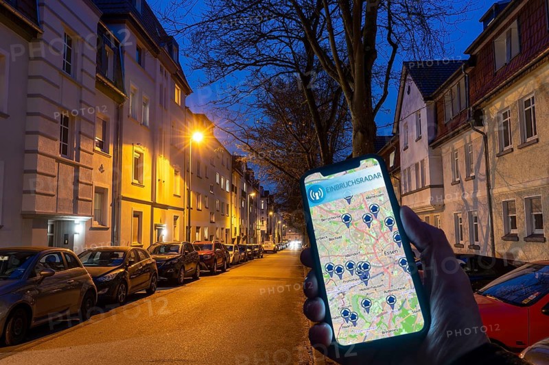 Symbolic image residential burglary, burglary radar app, shows the burglaries in the city, the last few days, residential street, many apartment buildings in a residential area, in the evening, lantern lighting, Essen, North Rhine-Westphalia, Germany