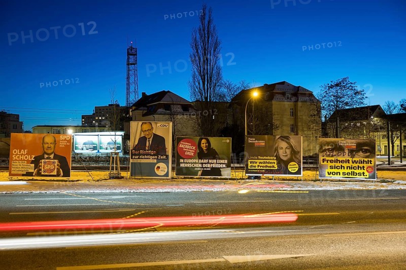 Election posters of the parties SPD, CDU, Bündnis 90/Die Grünen and FDP behind the lights of passing cars on the Nuthe-Schnellstraße in Potsdam for the election to the 21st Bundestag on 23 February 2025, taken on 19 February 2025