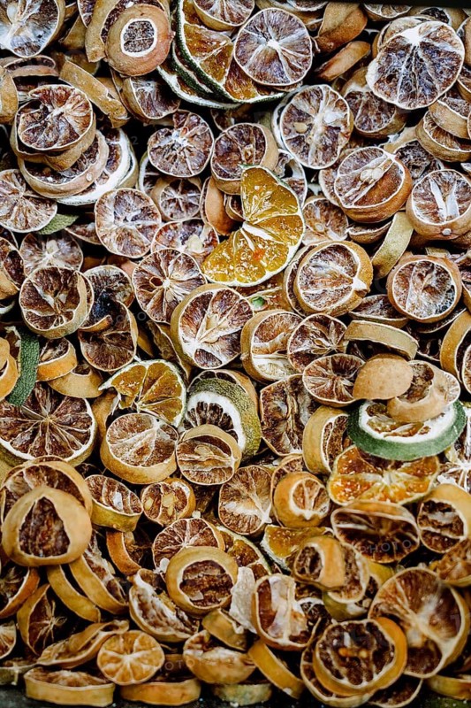 A collection of dried citrus slices featuring lemons and limes. Ideal for natural decoration, potpourri, or adding a unique flavor to beverages and culinary creations