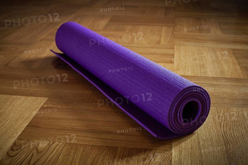 Yoga mat on wooden floor