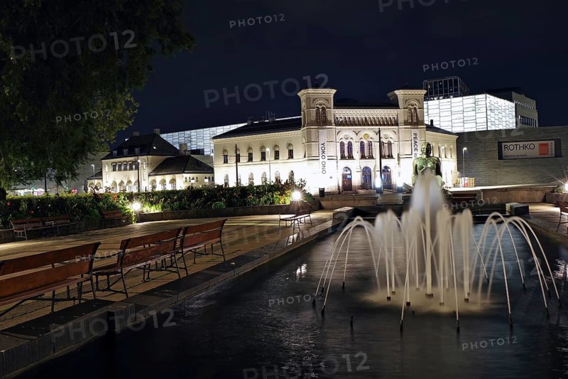 Historic building at night with illuminated fountain and benches in the foreground, old Ostbahnhof railway station, Nobel Peace Prize Centre