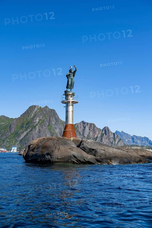 Figure Fiskerkona at the harbour of Svolvaer, mountains and sea, Lofoten, Nordland, Norway