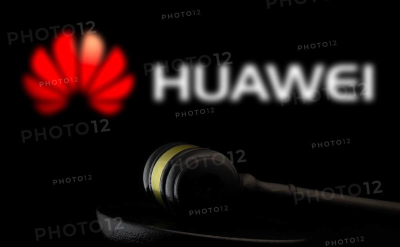 Court gavel in front of the Huawei logo.