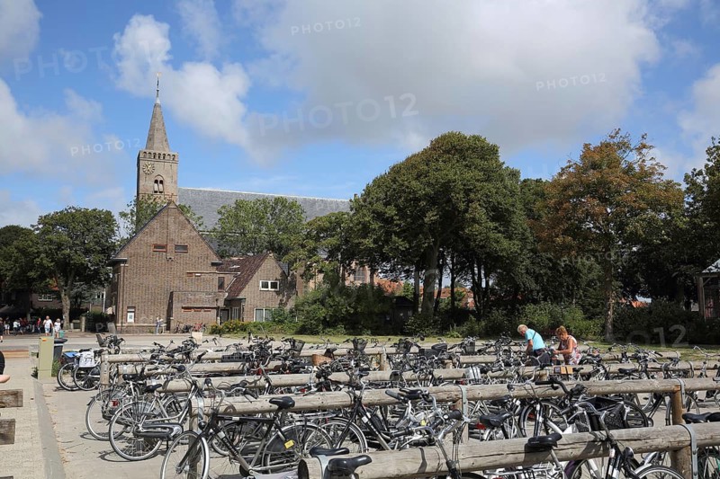 Church and bicycle parking, bicycles parked at the parking lot, cycling, parking lot, Den Burg, Texel, North Holland, Netherlands, Netherlands
