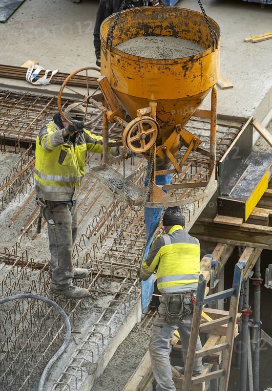 Construction site, concreting, the ceiling of a building is concreted, the concrete is placed on the reinforced concrete mats using a concrete bomb