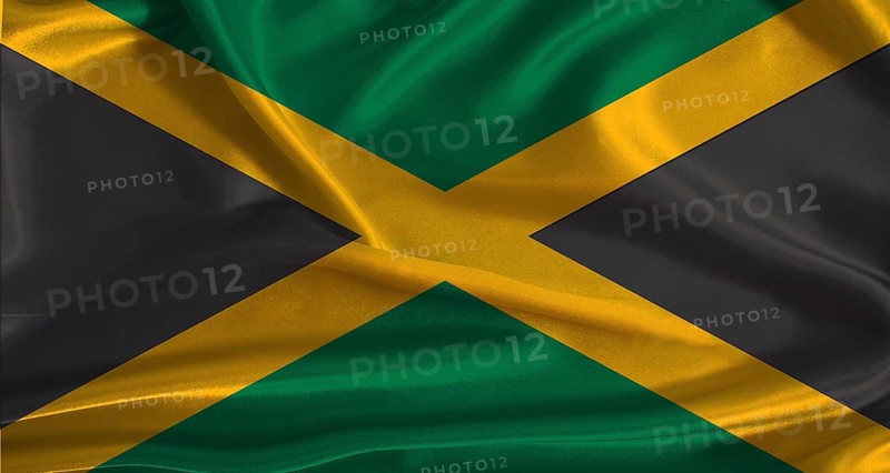 Jamaica flag with cloth textured background. National flag of Jamaica with realistic texture