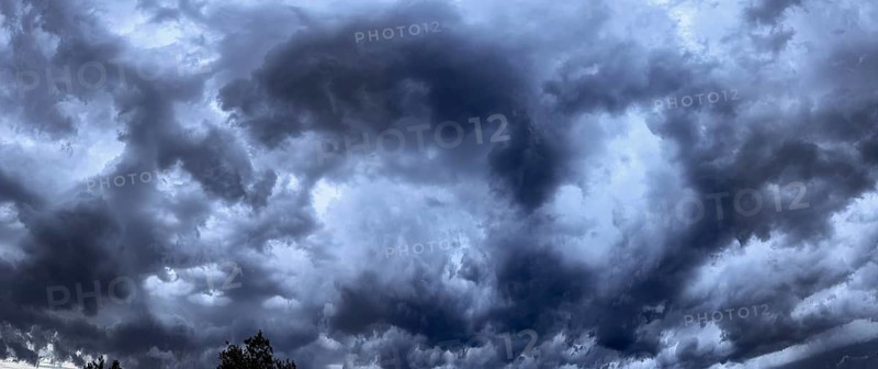 Panoramic photo of eerie atmosphere like apocalypse through dark thunderclouds Clouds during approaching thunderstorm and storm, Germany