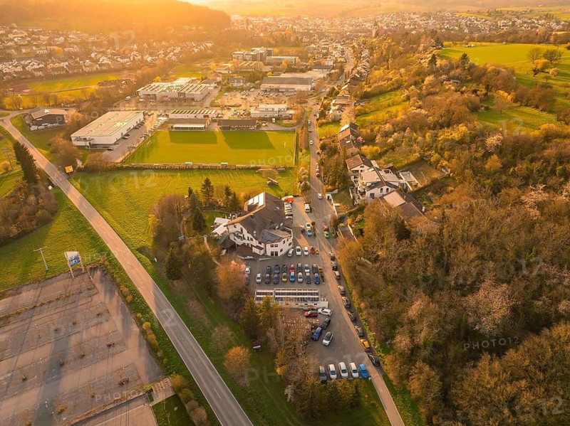 Aerial view of an urban landscape with fields and buildings at dusk, Europäischer Hof, Königsbach, Germany