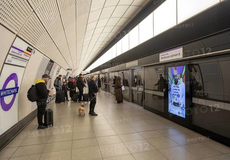 Passengers waiting on platform for Elizabeth Line underground train at Whitechapel railway station, London, England, UK