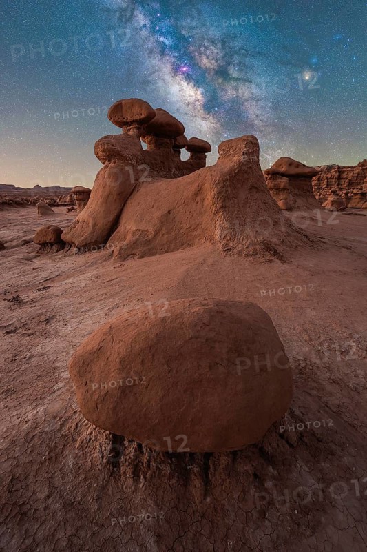 Breathtaking view of the Milky Way over unique sandstone structures in Goblin Valley State Park, Utah, USA. A serene night scene capturing the wonders of nature