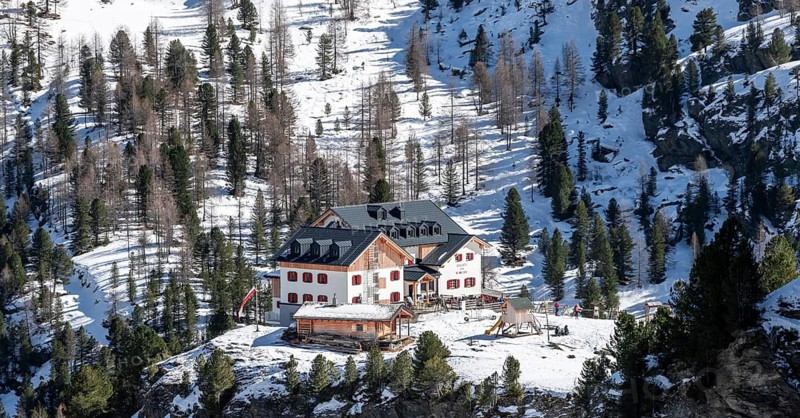 Zufallhütte mountain hut, view of the Martell Valley, snow-covered mountain landscape in winter, Ortler Alps, Vinschgau Valley, Italy
