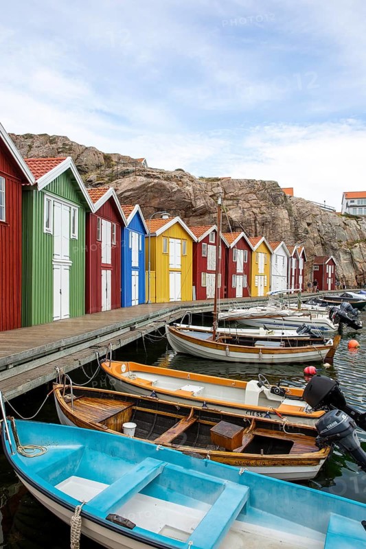 Small colourful houses by the sea. Typical houses in Sweden for the coastal landscape. Crab fishing and storage in a narrow harbour. Smögen, Smögenbryggan, Sweden