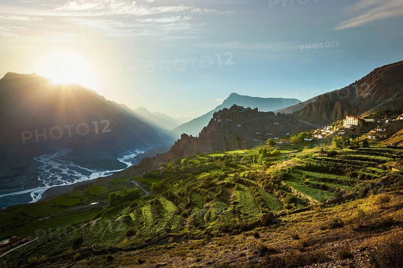 Dhankar gompa (monastery) on cliff and Dhankar village in Himalayas on sunset. Dhankar, Spiti valley, Himachal Pradesh, India