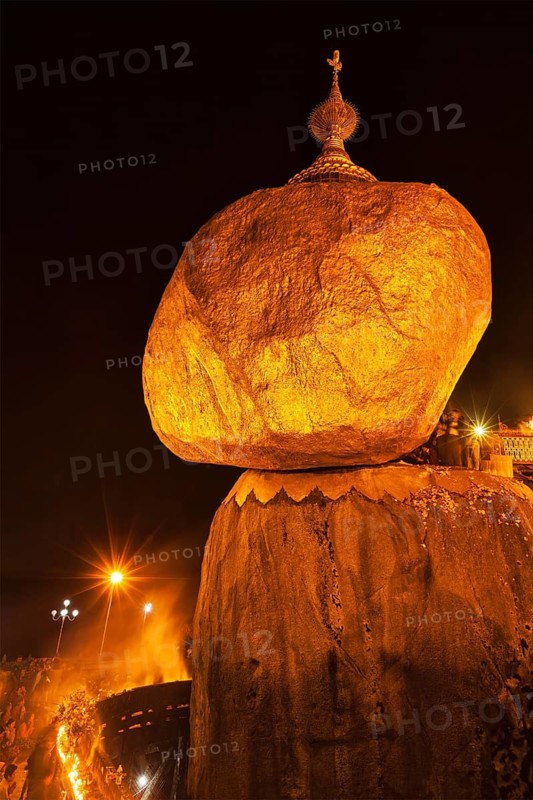 KYAIKTIYO, MYANMAR, JANUARY 4, 2014: People worshipping at Golden Rock, Kyaiktiyo Pagoda, famous Myanmar landmark, Buddhist pilgrimage site and tourist attraction, Myanmar