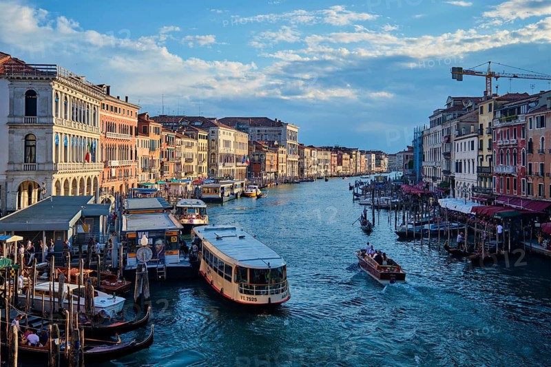 VENICE, ITALY, JUNE 27, 2018: Grand Canal with boats, vaporetto and gondolas on sunset from Rialto bridge, Venice, Italy