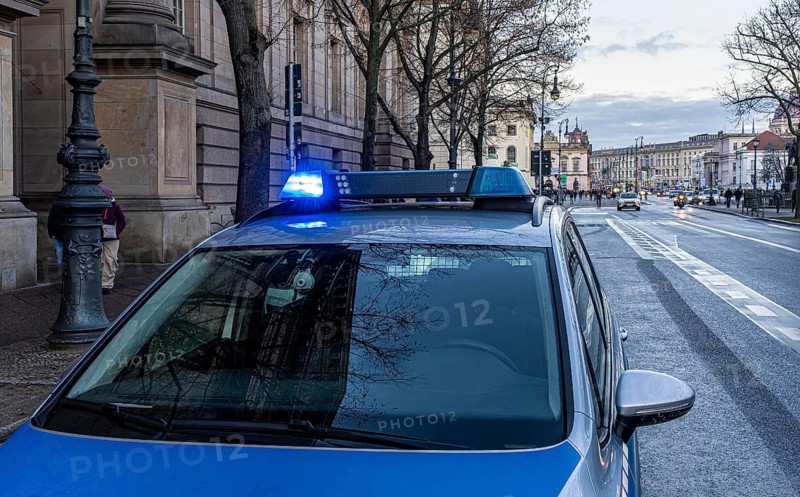 Police vehicles with flashing lights switched on, special operation at the Berlin State Library, Unter den Linden, Berlin, Germany