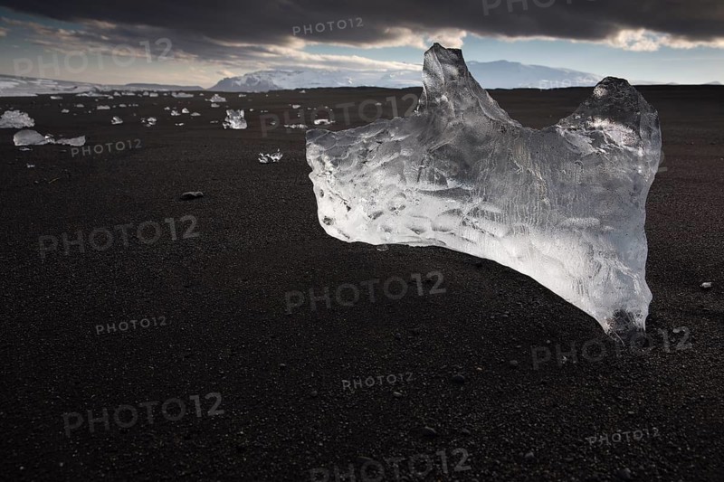 Little icebergs and crushed ice on the black beach at Joekulsarlon glacial lake