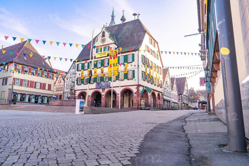 Square in the old town with half-timbered houses and colourful flags, sunny and quiet atmosphere, Fasnet, Weil der Stadt, Böblingen district, Germany