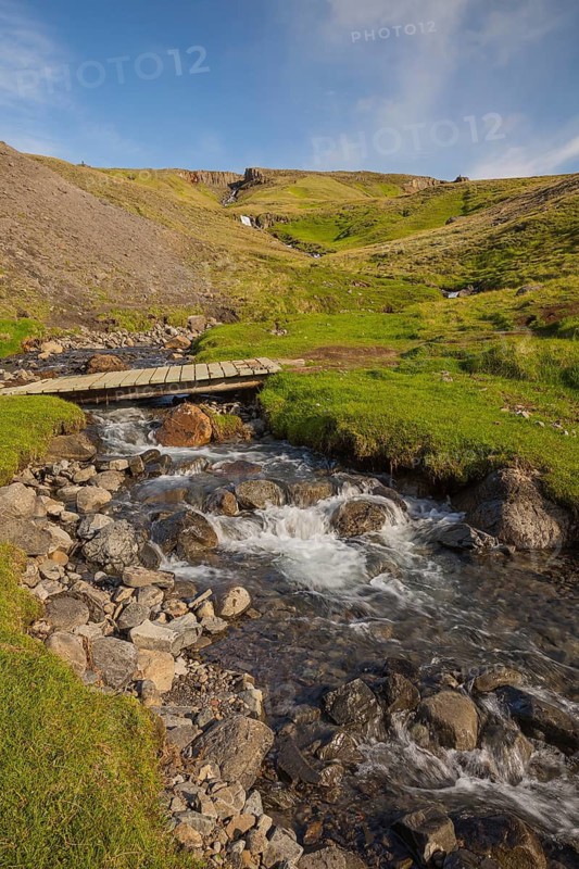 Flowing water below the waterfall. Hengifoss waterfall is located in Hengifossá in Fljótsdalshreppur, East Iceland. With 128 meters it is the third highest waterfall in Iceland