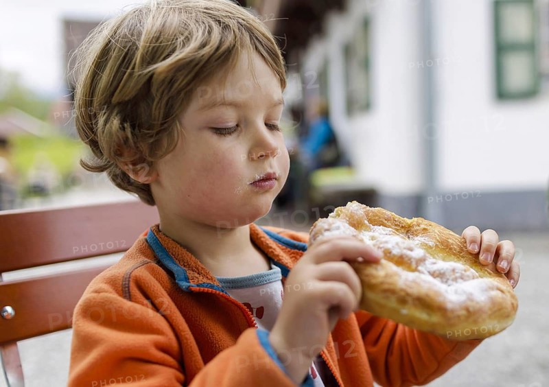 Topic: Child with an undressed man, a traditional Bavarian pastry, Murnau, 19.05.2023