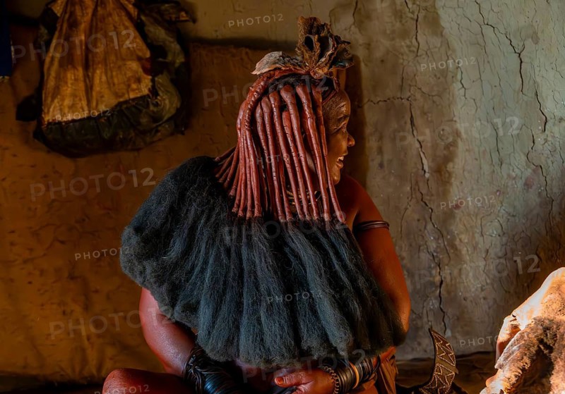 Traditional Himba woman shows her traditional hairstyle, near Opuwo, Kaokoveld, Kunene, Namibia