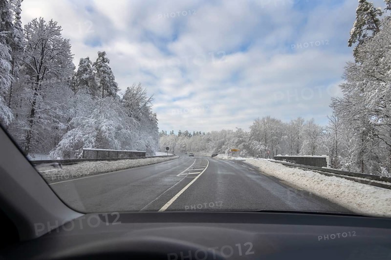 View from car, snowy landscape with cleared federal road, Heroldsberg, Middle Franconia, Bavaria, Germany