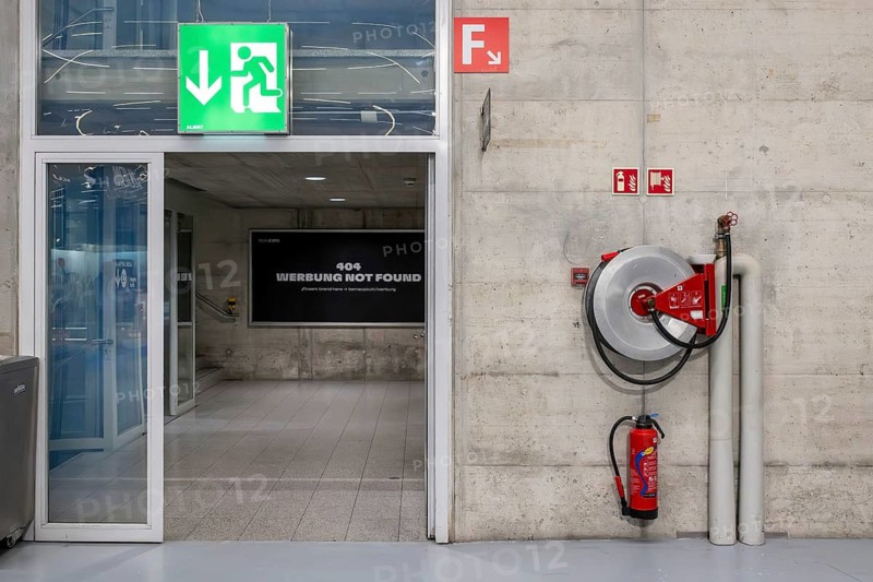 Symbolic photo of emergency exit, fire extinguisher and water hose, Bern, Switzerland