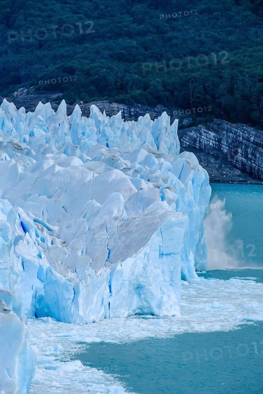 El Calafate, Patagonia, Argentina, Perito Moreno Glacier in Los Glaciares National Park. The Perito Moreno Glacier is part of the Patagonian ice field, the Campo Hielo Sur, the third largest freshwater reserve in the world. It is located in the province of Santa Cruz on Lago Argentino, the country's largest lake. The Perito Moreno Glacier is up to 30 kilometres long and 5 kilometres wide. Its edge is 70 metres high at its highest point. Small icebergs that have broken off from the glacier float in Lago Argentino. The glacier is one of the most beautiful sights in South America and is one of the most visited attractions in Argentina