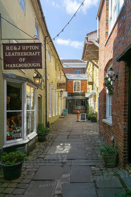 Specialist shops in Old Hughenden Yard alleyway, Marlborough, Wiltshire, England, UK