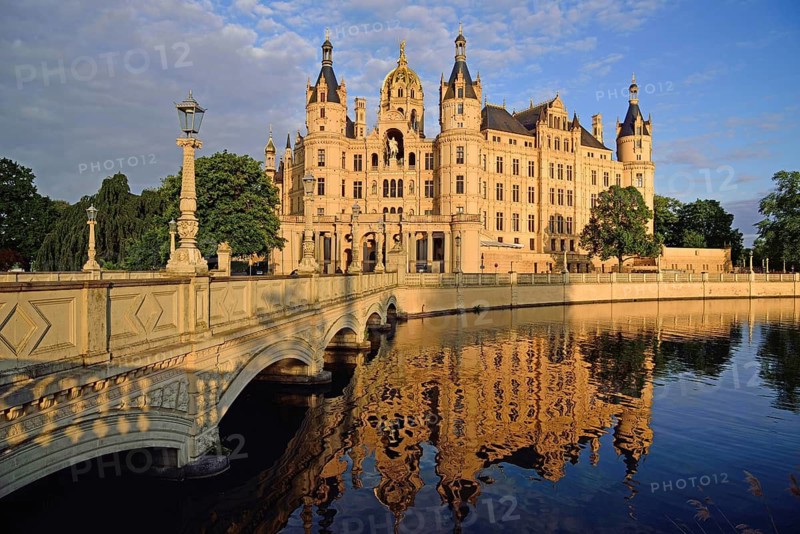 Europe, Germany, Mecklenburg-Western Pomerania, Schwerin, Schwerin Castle, built 1845 to 1857 in the style of romantic historicism, today seat of the state parliament, front with bridge to the castle island, evening light, Schwerin, Mecklenburg-Western Pomerania, Germany