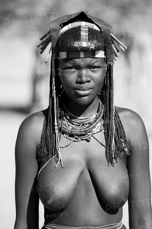 Black and white, portrait, brightly decorated woman of the Hakaona tribe, also Havakona or Hakawona, near Opuwo, Kunene, Namibia