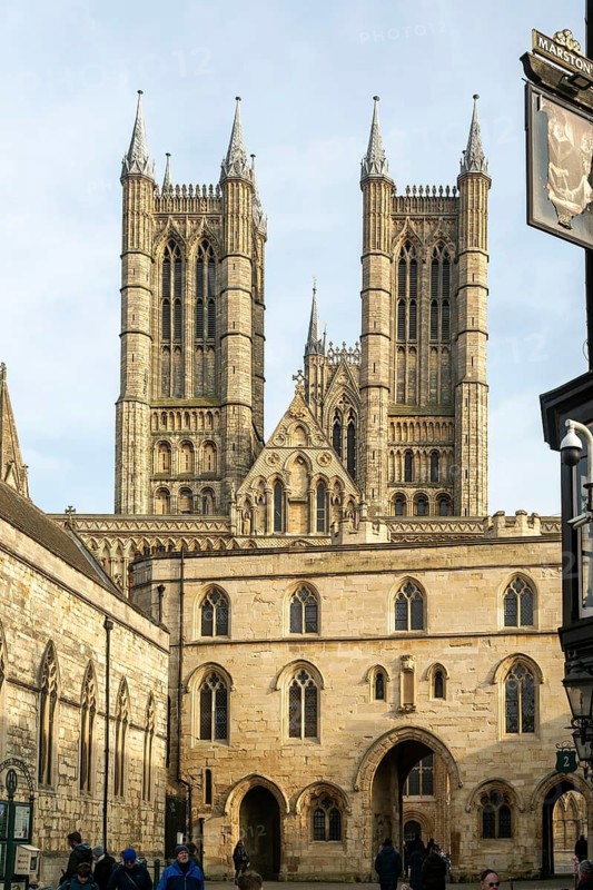 Towers of cathedral church rise above the medieval Exchequer Gate, Lincoln, Lincolnshire, England, UK