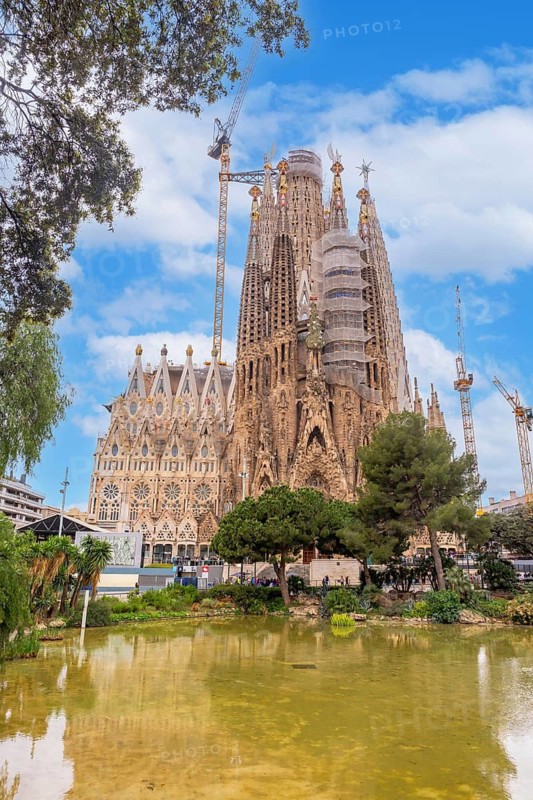 Basilica of the Sagrada Familia in Barcelona by the lake without people, Spain