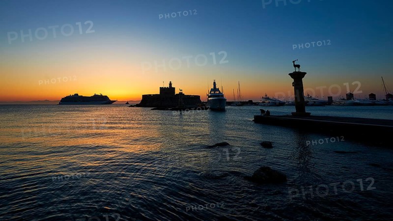 Quiet harbour with boats and a historic fortress, sunrise, dawn, Fort of Saint Nikolaos, Mandraki Harbour, Rhodes Town, Rhodes, Dodecanese, Greek Islands, Greece