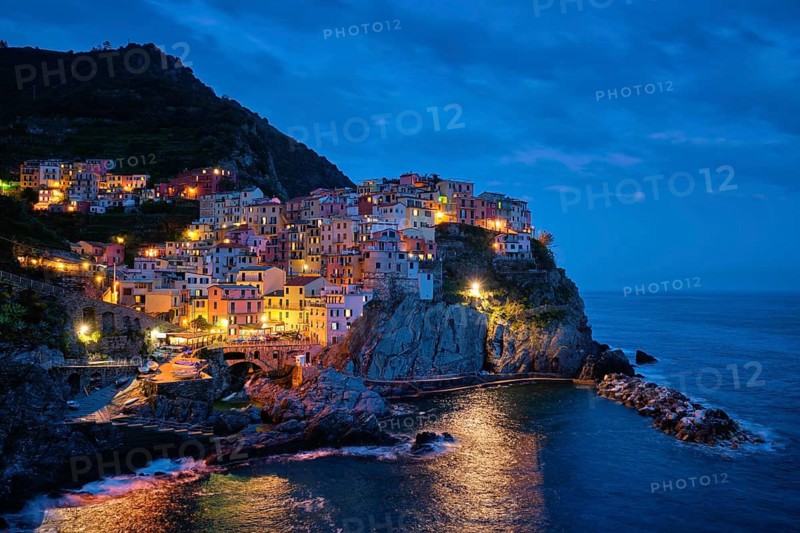 Manarola village popular european italian tourist destination in Cinque Terre National Park UNESCO World Heritage Site, Liguria, Italy illuminated in the evening