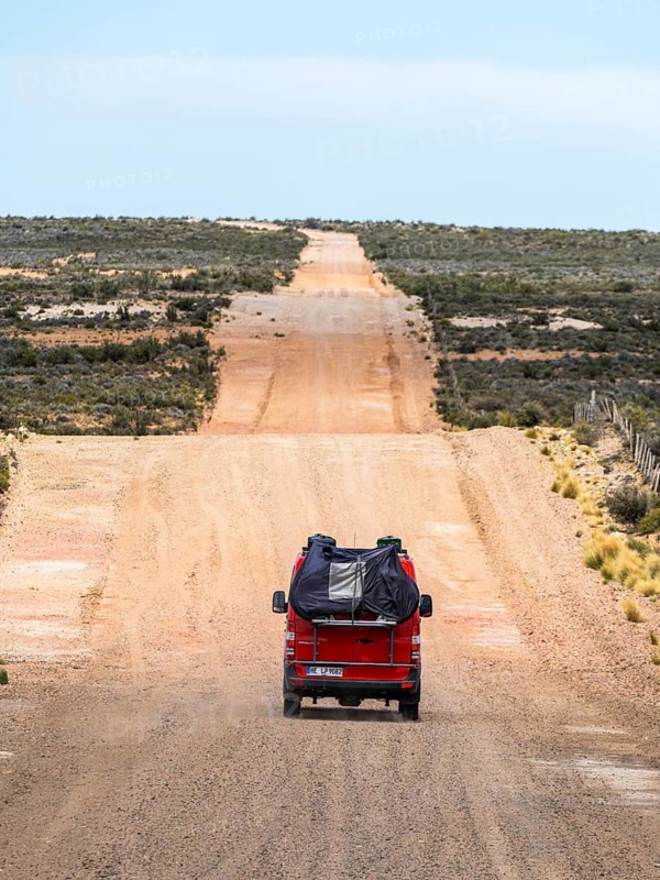 4x4 campervan drives along the road near Estancia la Maciega, Chubut, Argentina